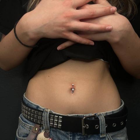Piercing pępka efektownie podkreśla linię brzucha. Ozdobna biżuteria nadaje stylizacji wyrazisty charakter.