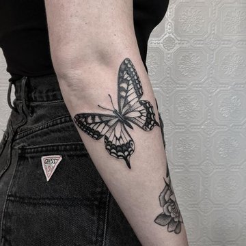 black-and-white-butterfly-on-the-side-of-the-arm-under-the-elbow-butterfly-and-flower-tattoo-black-and-white-photo.jpg