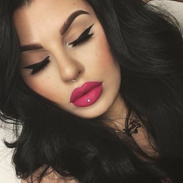 black-haired-woman-wearing-pink-matte-lip-stick-different-lip-piercings-black-eyeliner.jpg