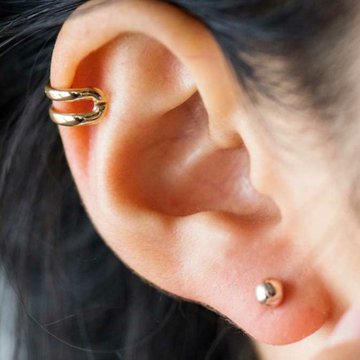 golden-earrings-triple-helix-piercing-close-up-photo-of-woman-with-black-hair.jpg