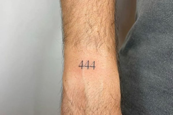 Minimalistyczny tatuaż 444 na przedramieniu