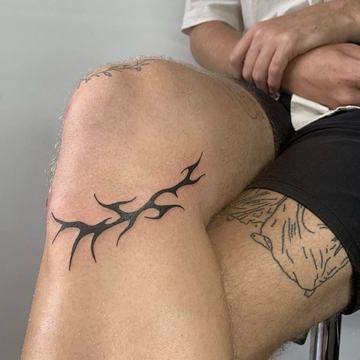 Tatuaż tribal na kolanie: czarne, ostre linie